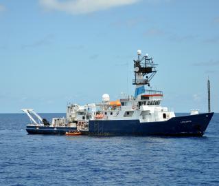 The small boat alongsides Endeavor.