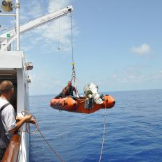 Dropping in the small boat to retrive the lander.