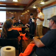 Captain Pavel briefs the team in the Mess after the Muster drill. 