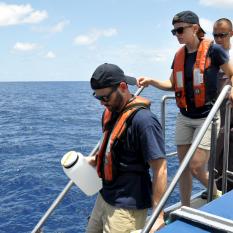 Lead scientist aboard Nautilus, Dr. Erik Cordes, and members of his team head down to the small boat.