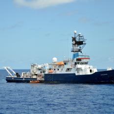 The small boat alongsides Endeavor.