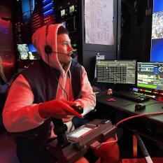 Jacob sits in a dark control room